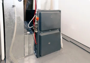Furnace Installation in El Reno, OK 1 A furnace with a hose connected, showcasing its design and functionality in a heating system setup.